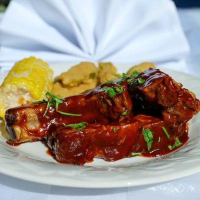 Pork ribs served with coen and fries ocra.