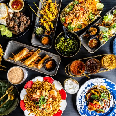 Large spread of assorted Thai dishes.