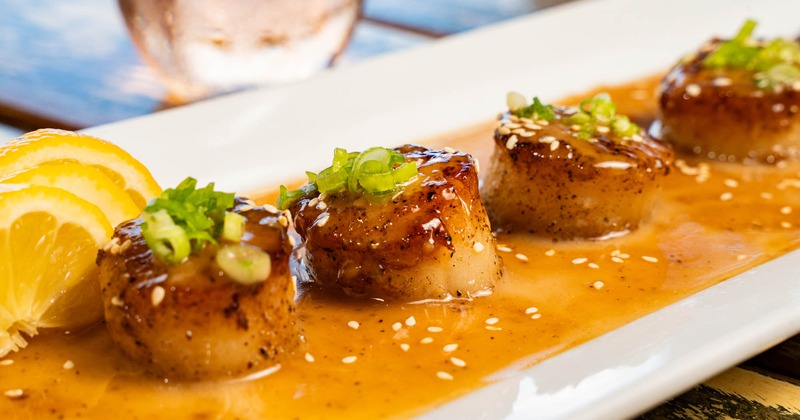 Sesame Ginger Scallops on a white plate