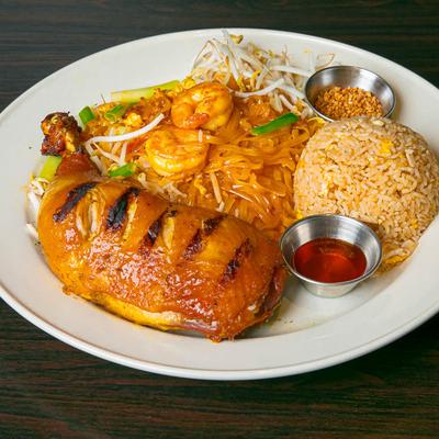 Grilled chicken leg, with noodles, shrimp, and rice.