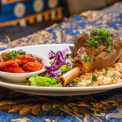Lamb Shank served with basmati rice and eggplant stew.