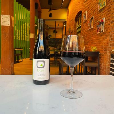 A bottle and glass of red wine.