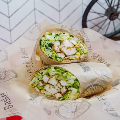 Chicken Caesar Wrap, sliced in half and served.