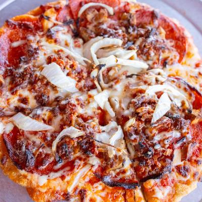 Three pig pizza, close up.
