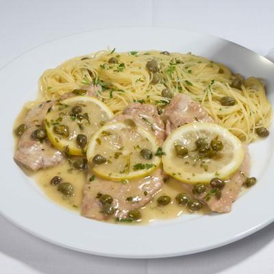 Veal piccata with lemon caper sauce and spaghetti.