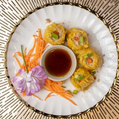 Steamed dumplings with dipping sauce.