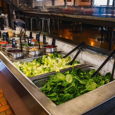 Metal containers with various pizza toppings.