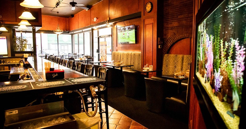 Interior, banquette benches with tables and chairs, bar area