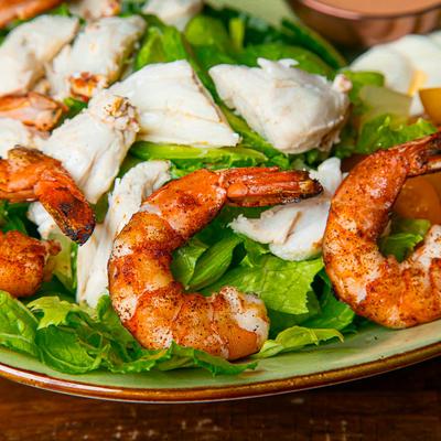 Grilled shrimp and crab meat on a bed of lettuce.