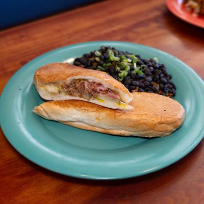 Cuban sandwich with rice and black beans on the side.