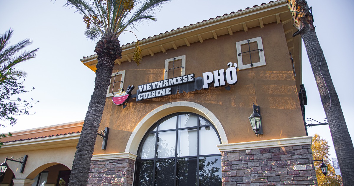 Exterior, angle view to front of restaurant, entrance, sign above