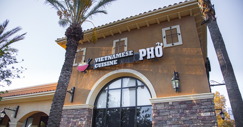 Exterior, angle view to front of restaurant, entrance, sign above
