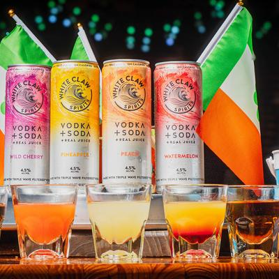 Cans of White Claw drinks and shot glasses.