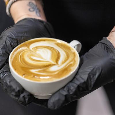 Latte with heart art in a white cup.
