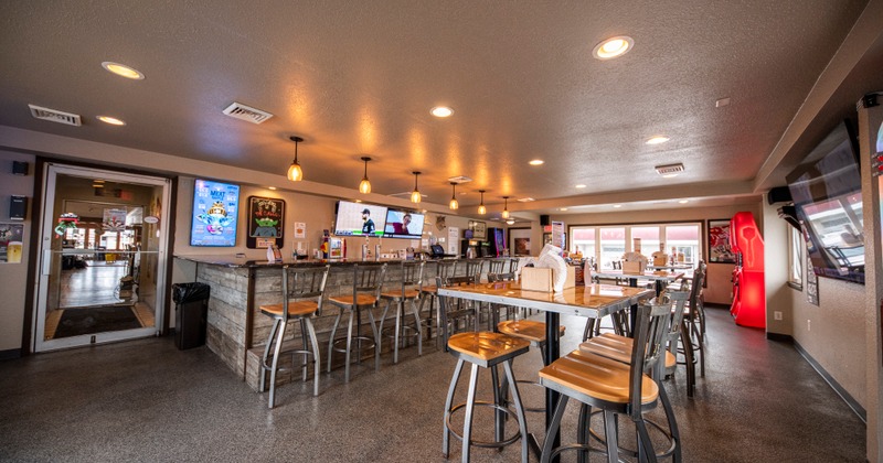 Interior, tall chairs lined up at the bar area