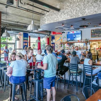 Interior, customers sitting at tables and a bar counter.