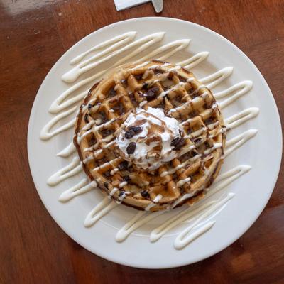 Roll Waffle with  pecans, raisins, cream cheese icing, and cinnamon glaze.