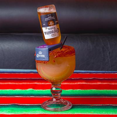 Coronarita cocktail served on a colorful tablecloth.