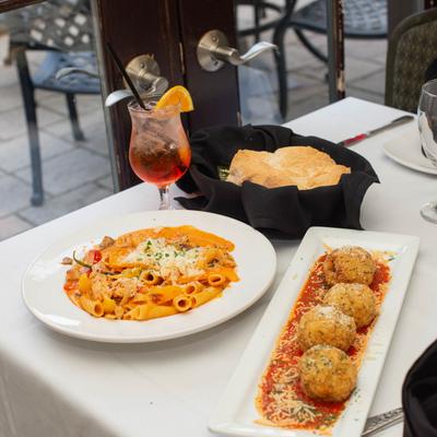 Various food and Aperol Spritz on the table.