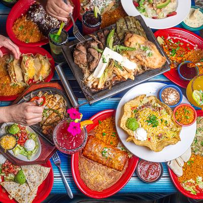 Assortment of dishes spread on a table, overhead view.