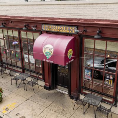 Restaurant storefront, front entrance with red awning.