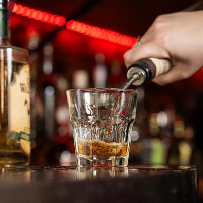 Pouring a glass of whiskey.