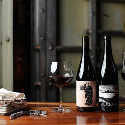 Bottles and a glass of red wine.