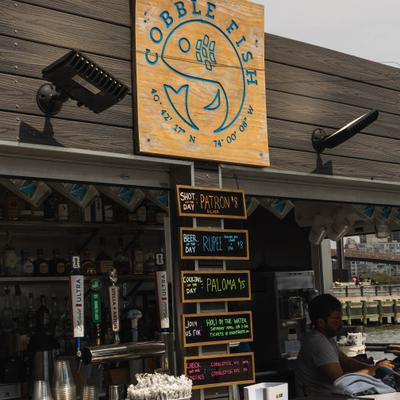 Bar service area featuring menu boards and restaurant's signage.