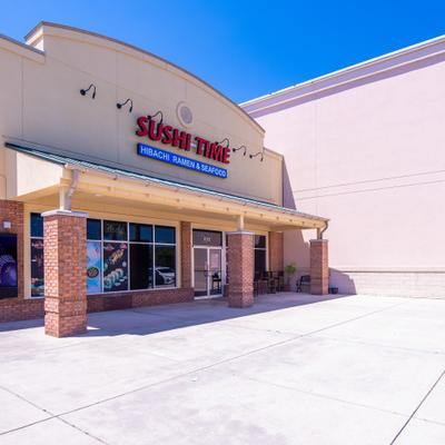 Side view of the storfront with entrance and signage.