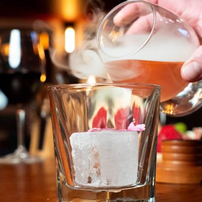 A hand pouring a drink.