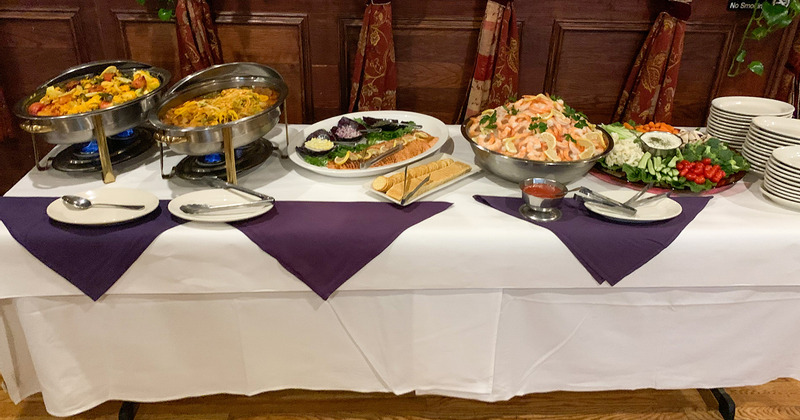 Inside, a table with catering food and plates for self serving