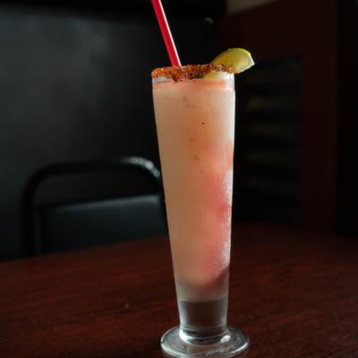 Paloma cocktail garnished with lime wegde.