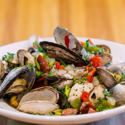 Loaded steamer clams, cooked in onions, peppers, chorizo, garlic butter, and beer.