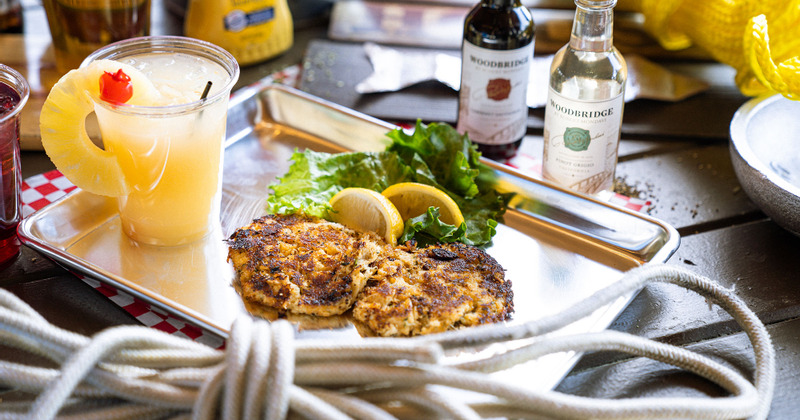 Crab cake served with a fruit drink