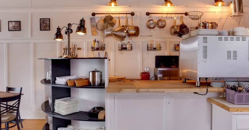Interior, old fashioned kitchen counter with copper pots, pans and utensils