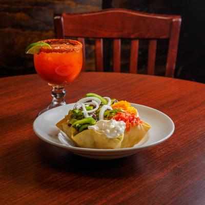 Michelada cocktail and a Mexican taco salad