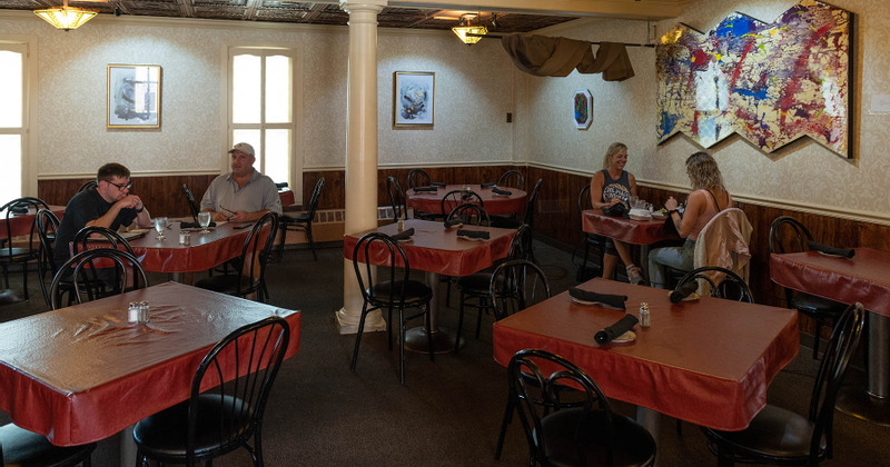 Restaurant interior, guests enjoying drinks and food