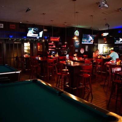 Interior, pool tables with dining area in the back