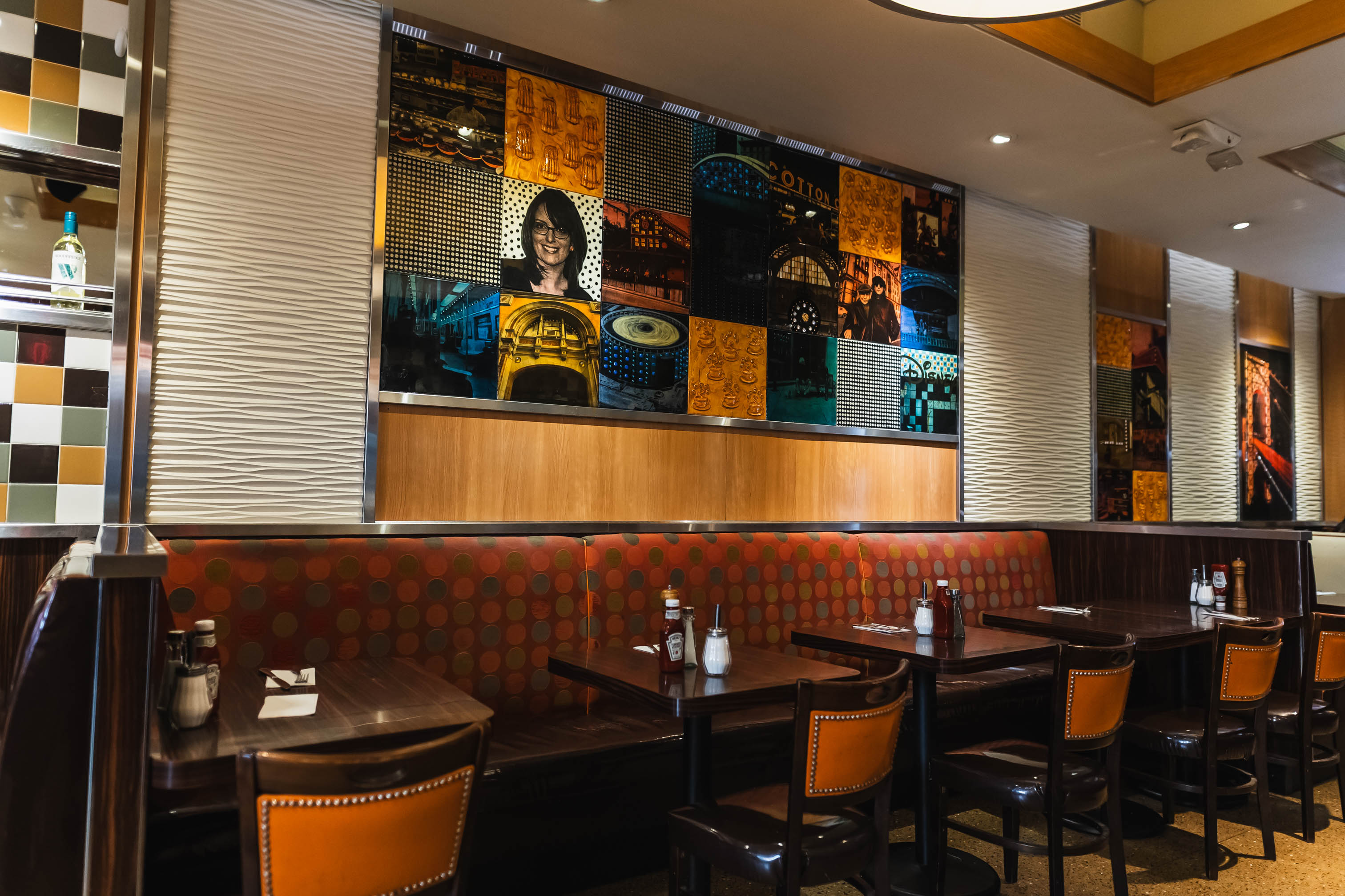 Interior with a mix of booth and table seating and colorful pop-art style mural