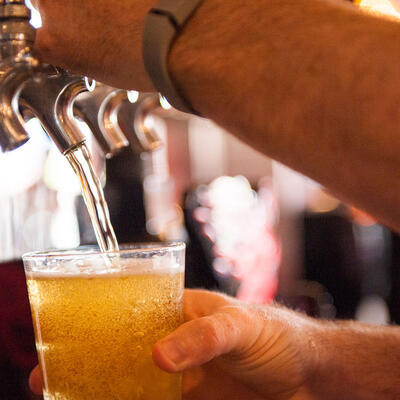 Employee pouring draft beer