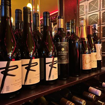 Interior, Shelf and rack with bottles of wine.