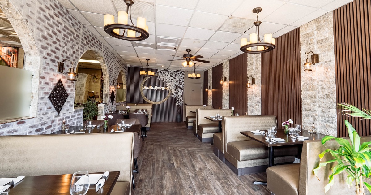 Interior of a modern restaurant featuring booths, and stylish light fixtures