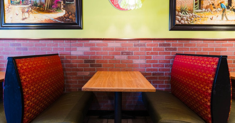 Interior, dining area, padded seating booth with wooden top table