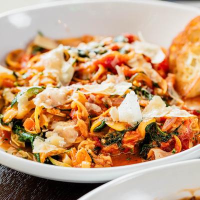 Zucchini noodles with spinach, Parmesan, and tomatoes.