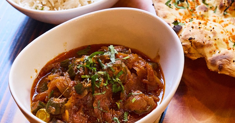 Karahi Chicken with sides of rice and naan