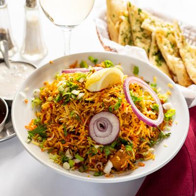 Biryani plate and a basket of garlic naan.