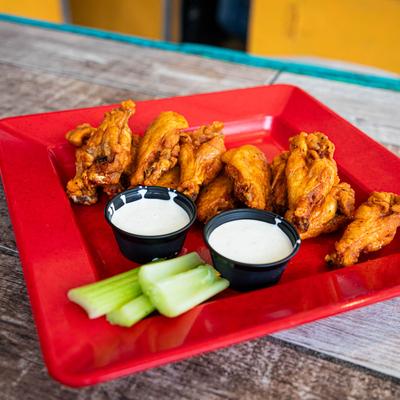 Wings with celery and ranch sauce.