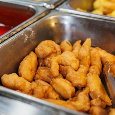 Fried chicken pieces in a buffet tray.