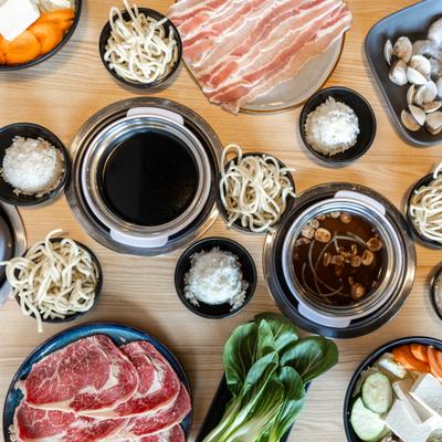 Various meats, veggies and ingredients on the table, top view.
