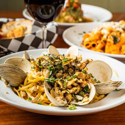 Linguine pasta topped with clams and chopped parsley.